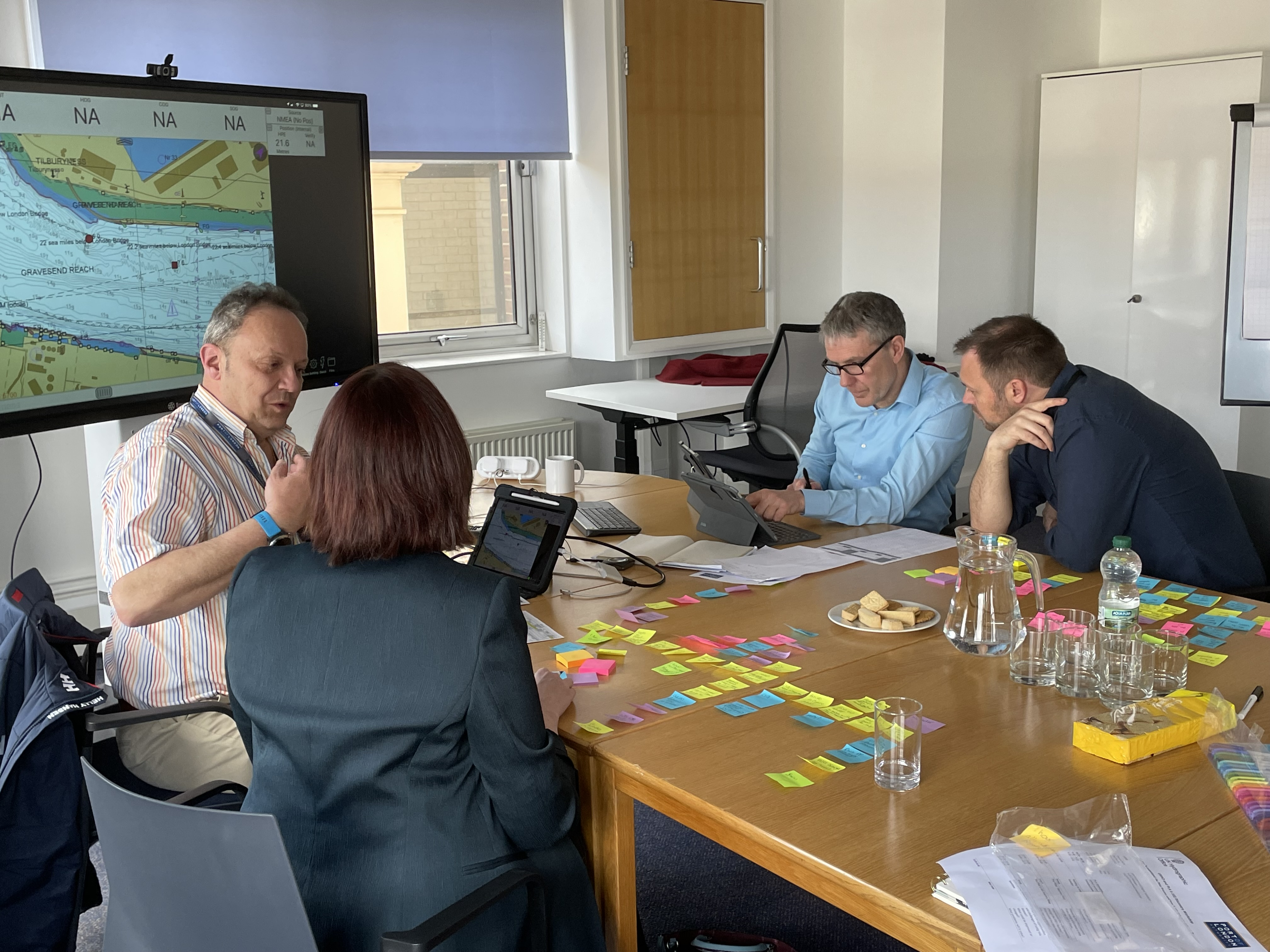 UKHO and Port of London Authority members looking at screen during shore based trial