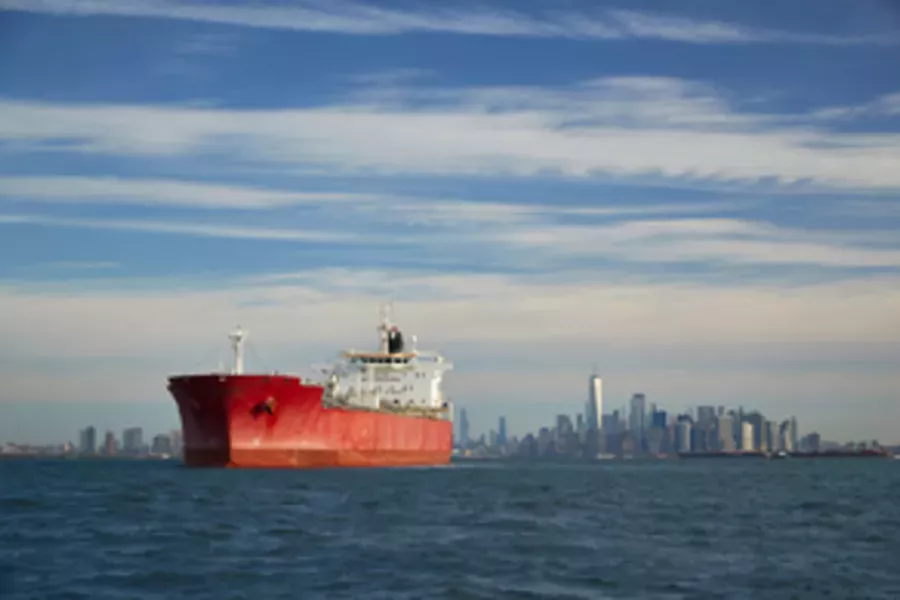A commercial ship leaving a port in New York
