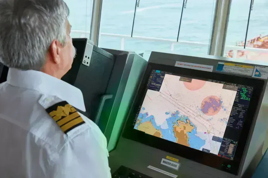 Captain checking position on ECDIS