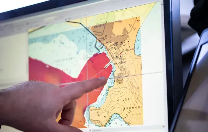 Hand pointing at AVCS screen