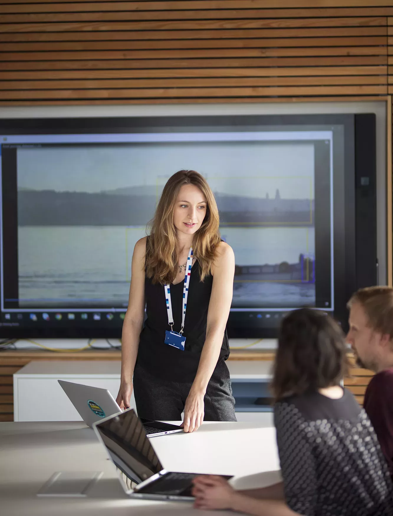 Staff member presenting in front of screen