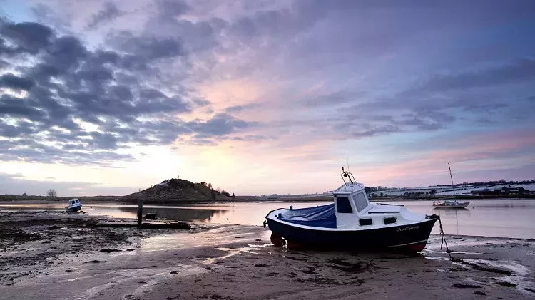 Boat on a beach at sunrise