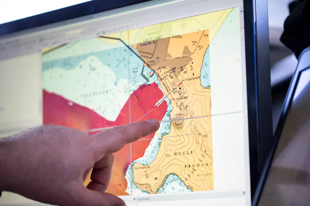 Hand pointing at data on a screen