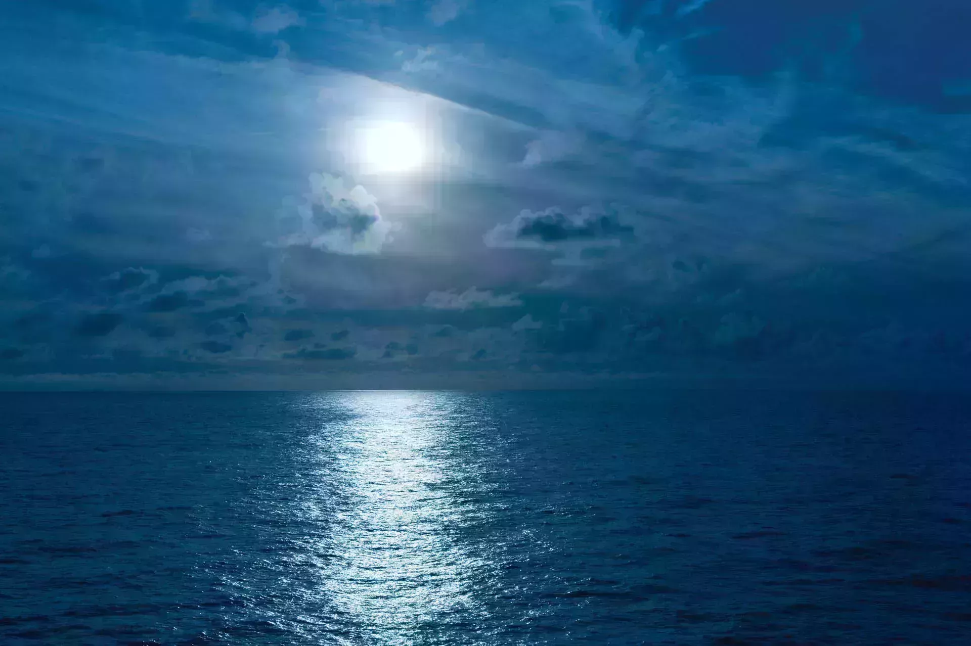 Full moon casting reflection across the ocean's surface