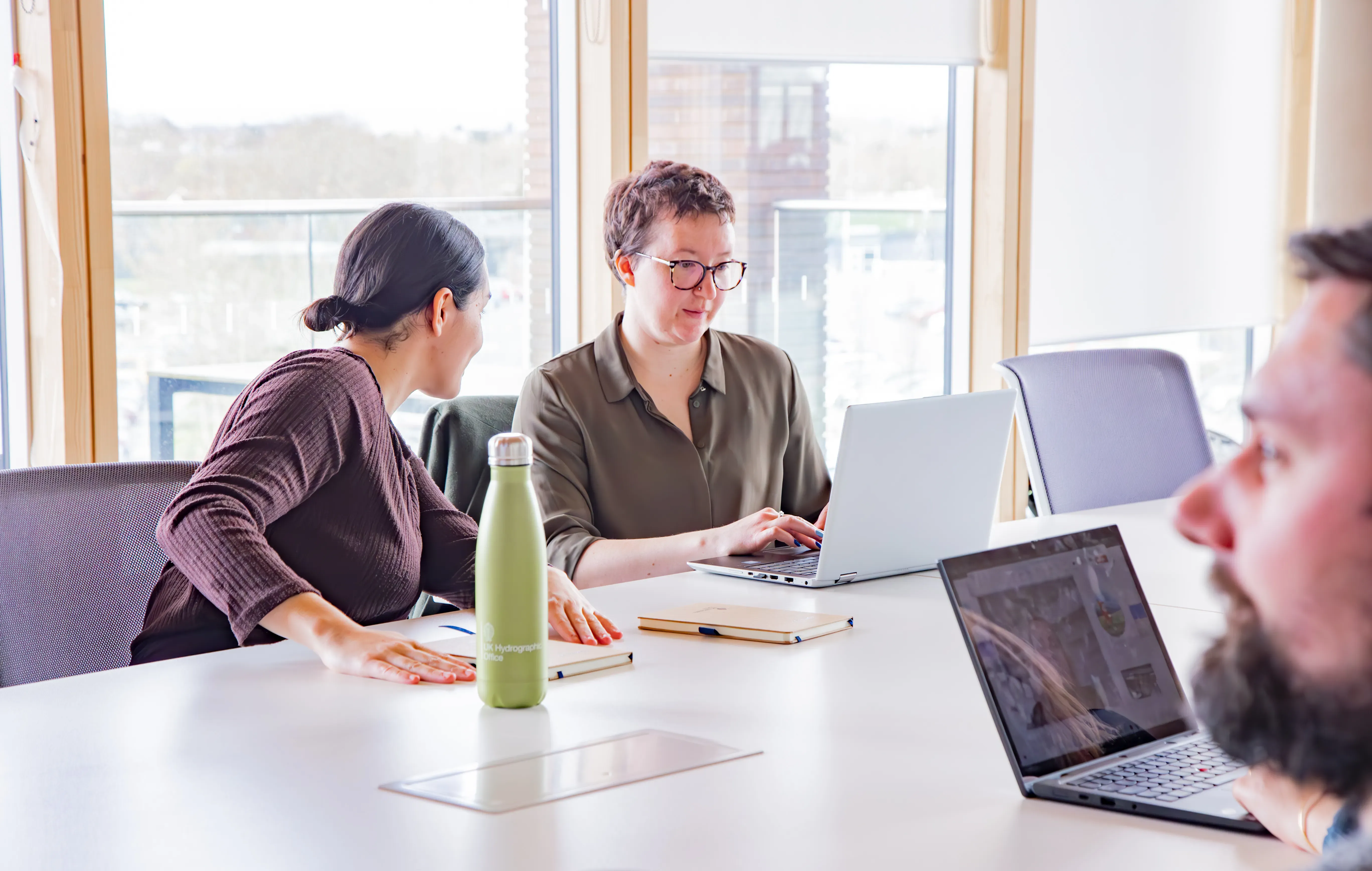 Staff members at meeting room table
